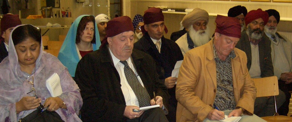 Visitors with head coverings at a gurdwara, South Asian wedding guest attire