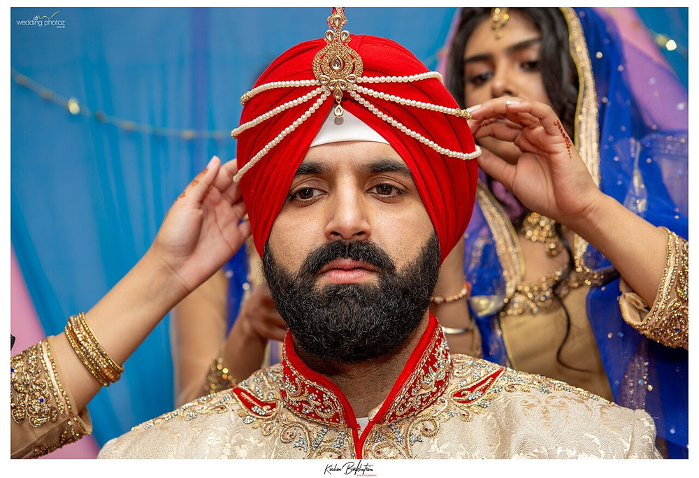 Groom turban with kalgi jewel at pre-wedding ritual, South Asian wedding