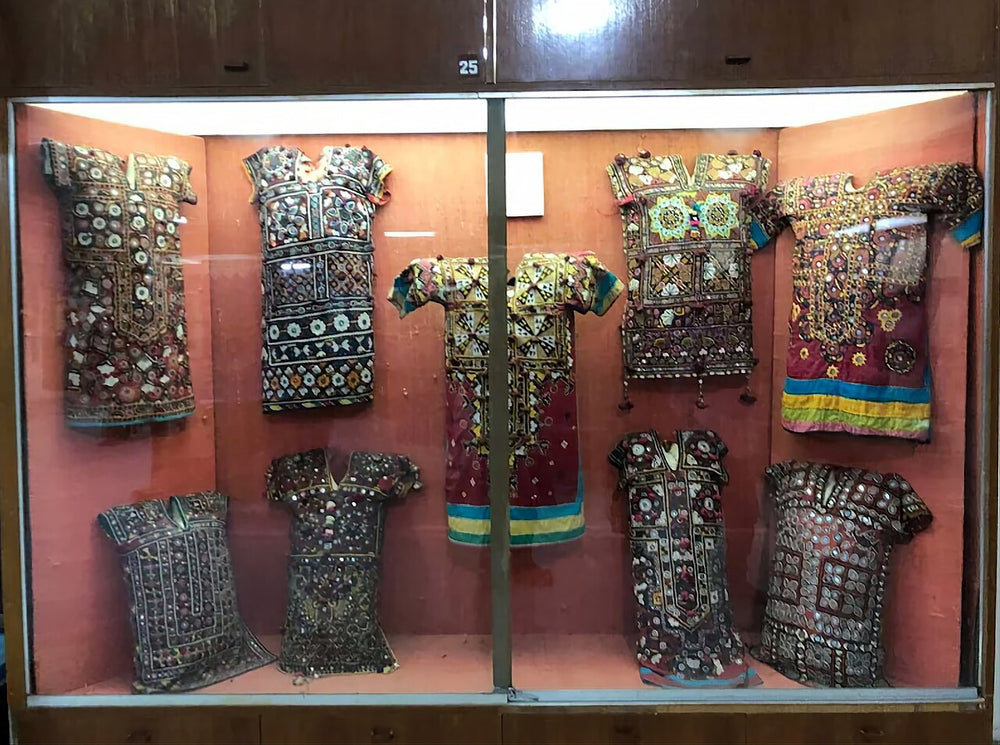 Traditional Sindhi embroidered gaj tunics with mirror work in a museum display